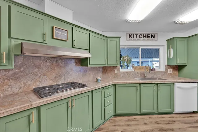 a kitchen with stainless steel appliances granite countertop a sink and cabinets