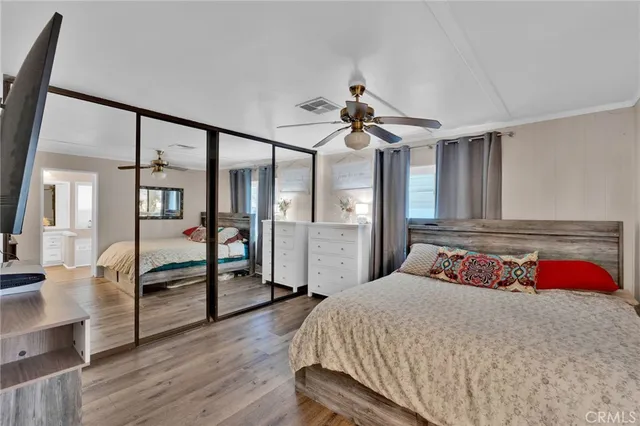 a bedroom with a large bed and a chandelier