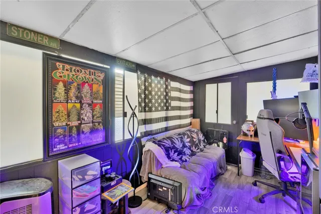 a bed room with a bed and a painting on the wall