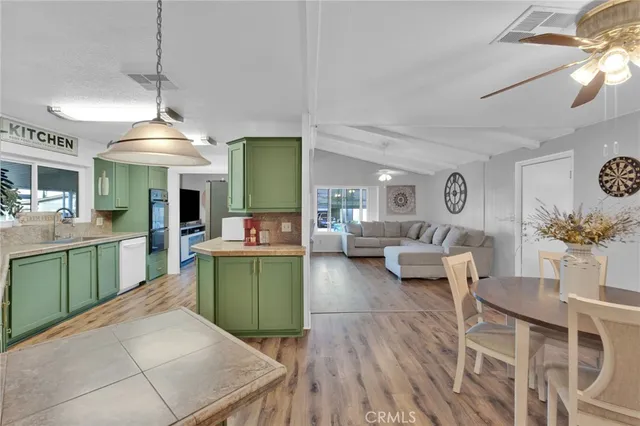 a kitchen with kitchen island a sink table and chairs