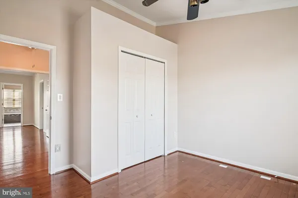 a view of empty room with wooden floor