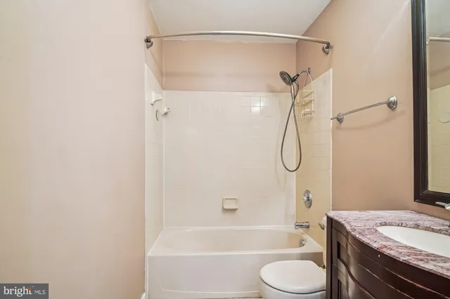 a bathroom with a sink a toilet and a shower