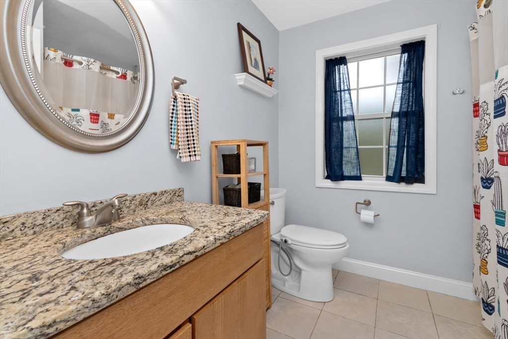 29 Spruce Street, Unit 23 Waltham, MA 02453 - Photo 17 of 26 a bathroom with a sink and a mirror