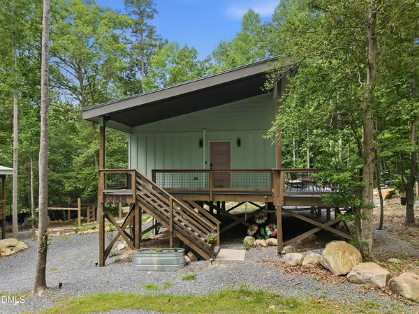 a view of a wooden deck and a backyard