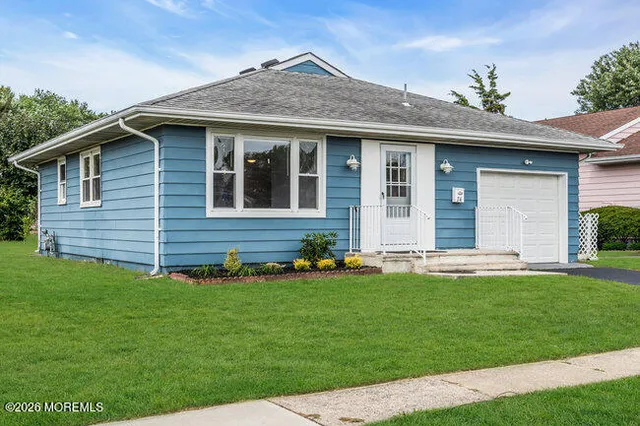 a front view of a house with a yard and porch