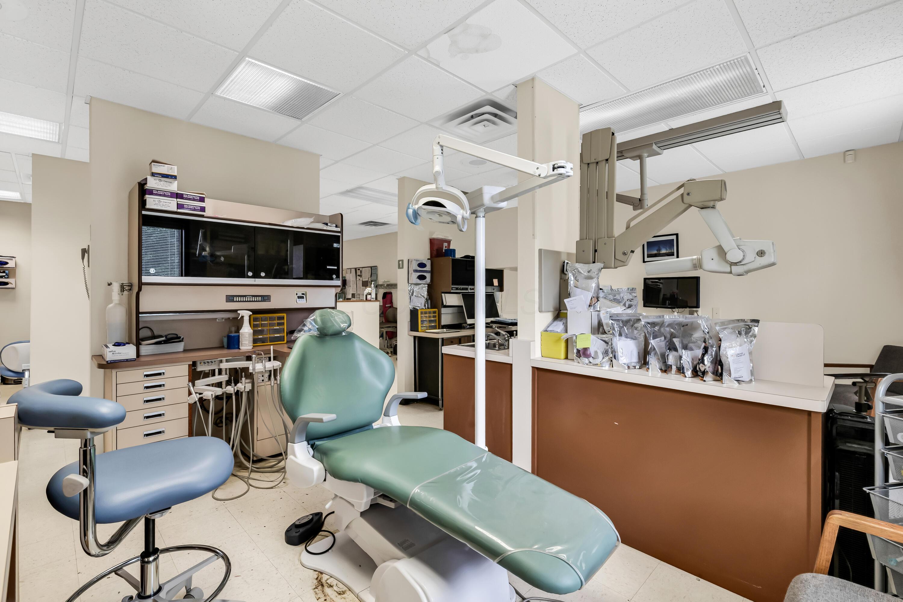 1240 Crescent Heights Road Marion, OH 43302 - Photo 38 of 60 • Neutral vinyl flooring • Ivory painted walls • Acoustic ceiling tiles • Fluorescent lighting • Enclosed vanity with single bowl, stainless steel sinktop • Divider • Lighting & equipment do not remain • Plumbed for oxygen & nitrogen