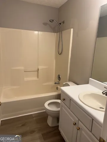 a bathroom with a sink toilet vanity and shower
