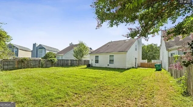a view of a house with a yard and tree s