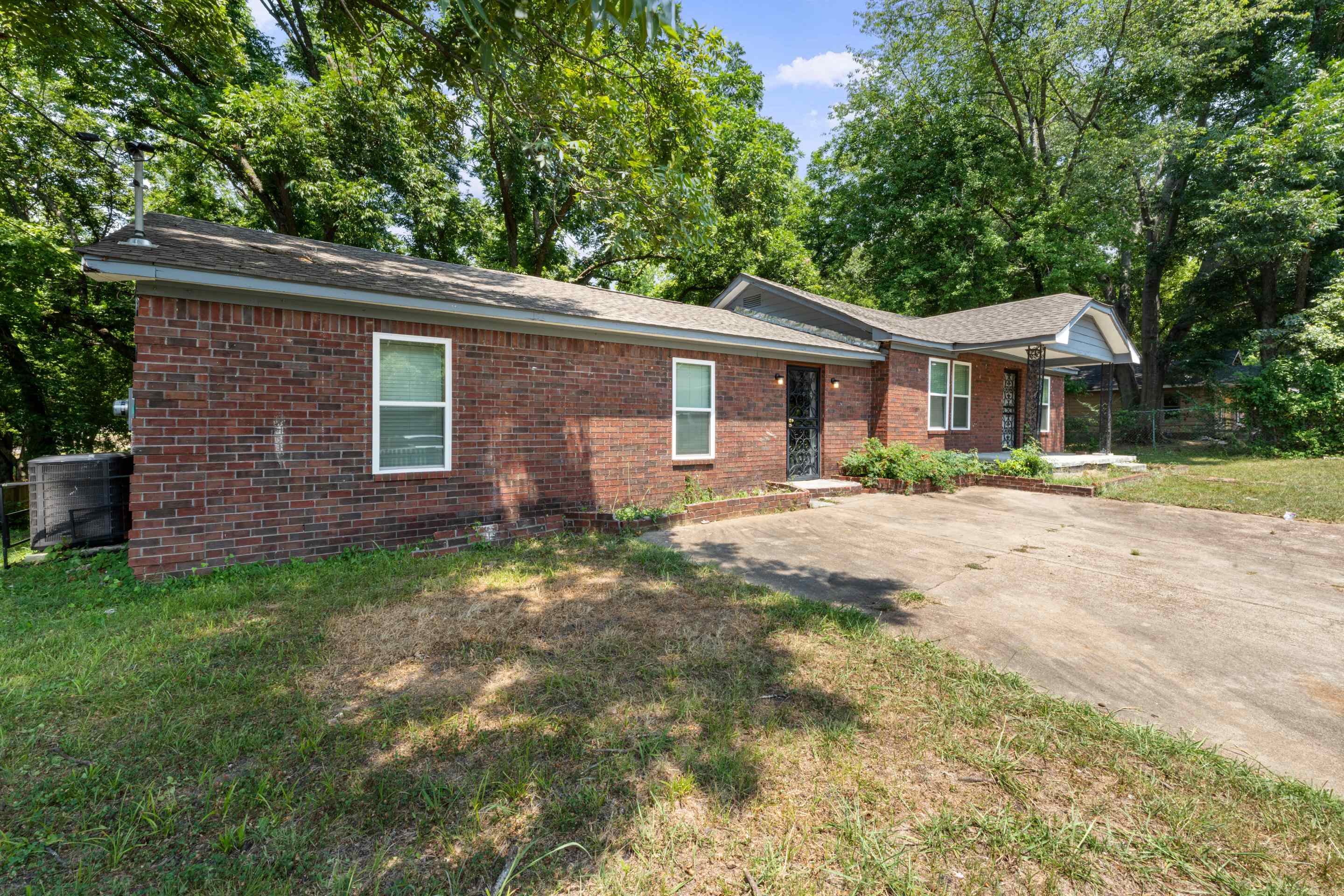 Single story home with brick siding and a front yard