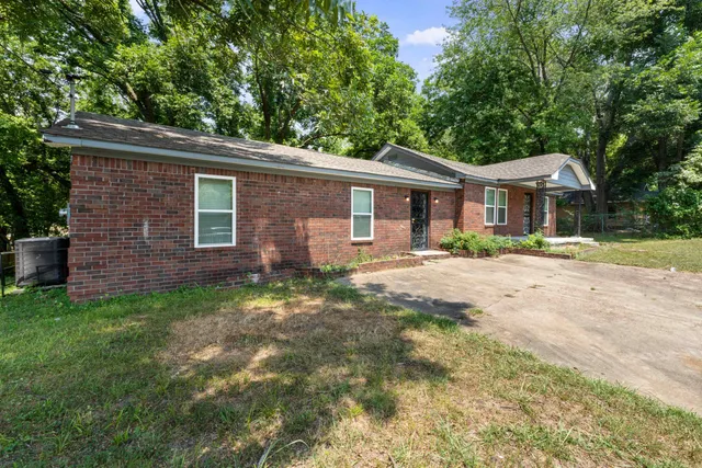 a front view of a house with a yard and porch