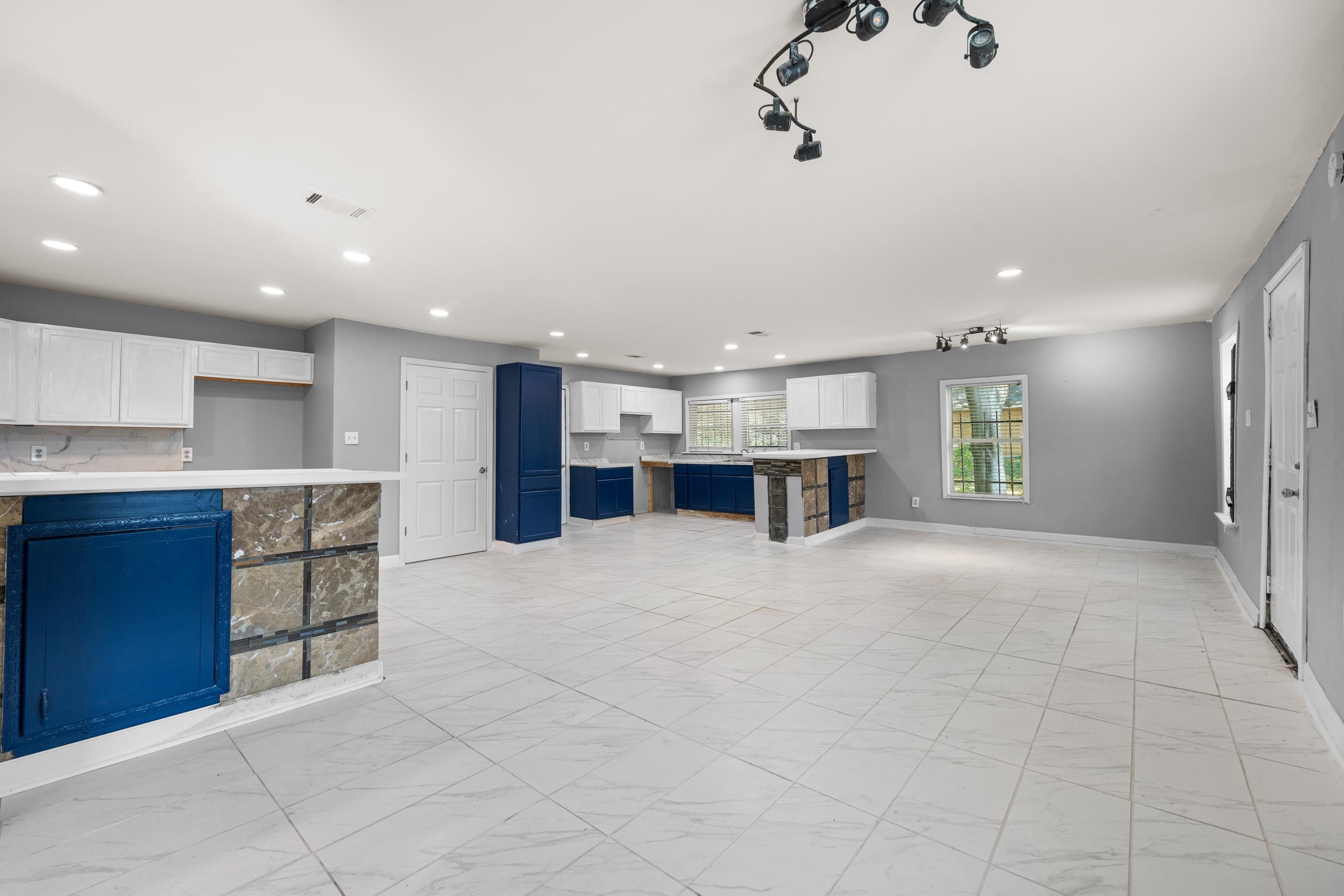 726 Harahan Road Memphis, TN 38109 - Photo 12 of 24 Unfurnished living room featuring recessed lighting, light marble finish floors, and track lighting