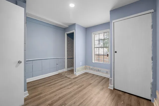a view of empty room with wooden floor