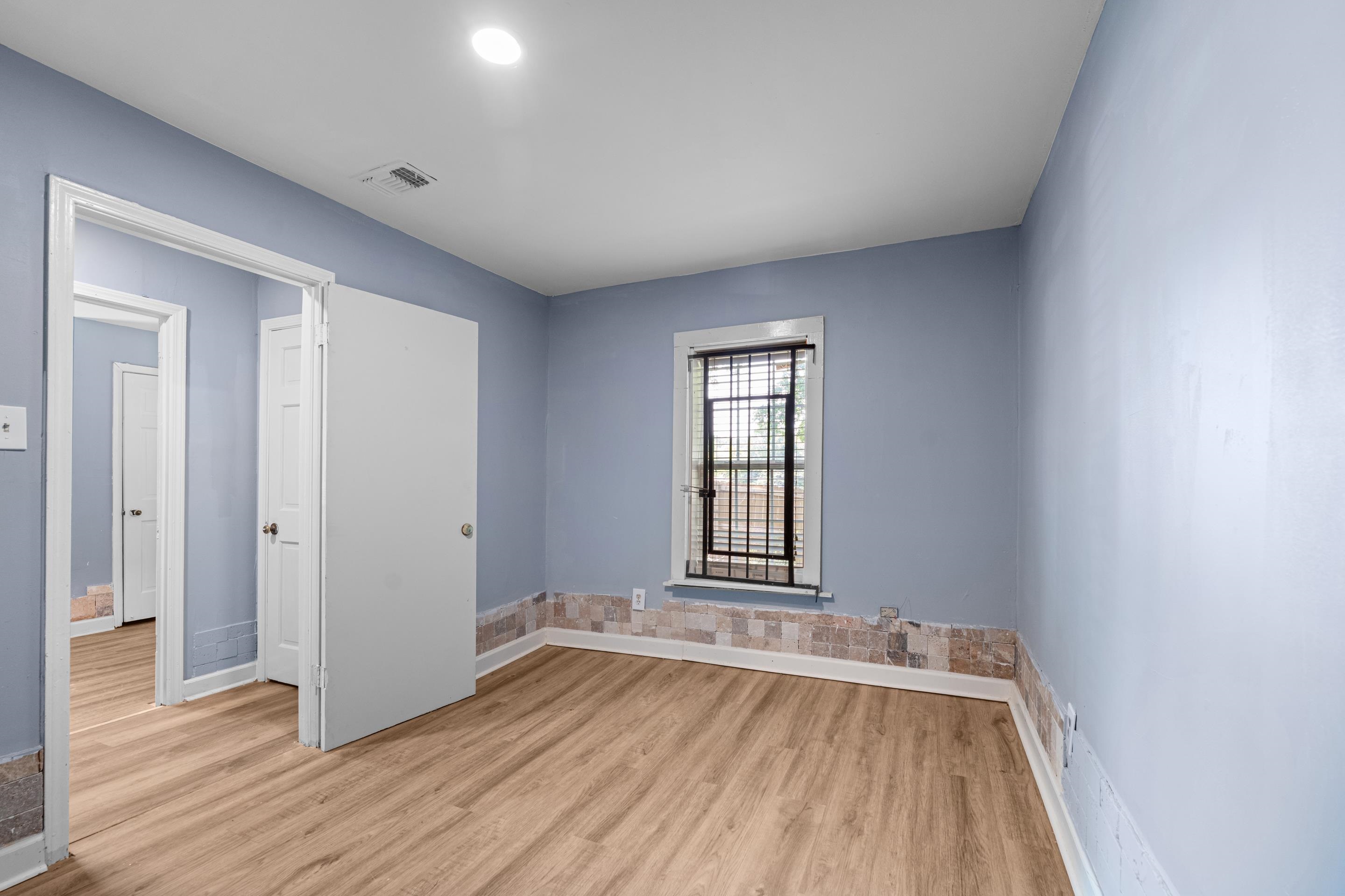 726 Harahan Road Memphis, TN 38109 - Photo 18 of 24 Empty room with light wood finished floors and baseboards