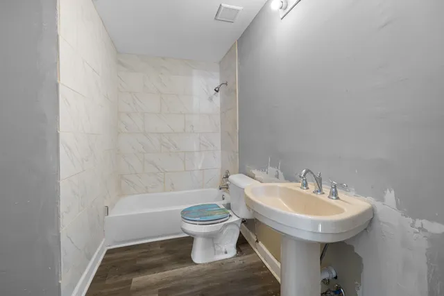 a bathroom with a bathtub and a shower