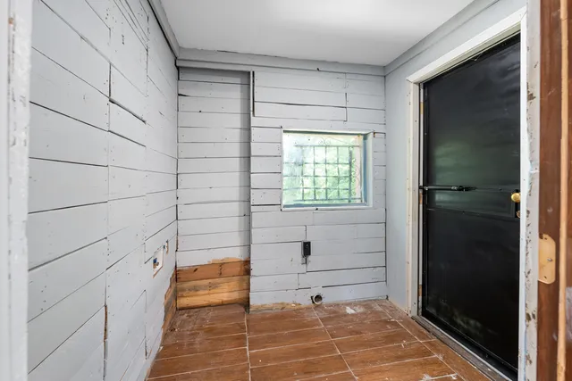 a bathroom with a granite countertop toilet sink and mirror