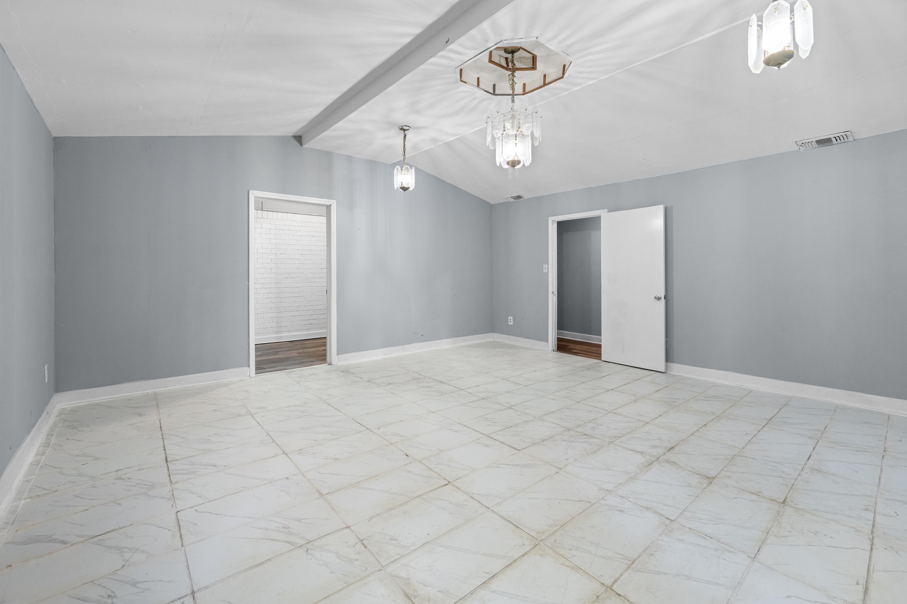 726 Harahan Road Memphis, TN 38109 - Photo 7 of 24 Spare room featuring light marble finish flooring and a chandelier