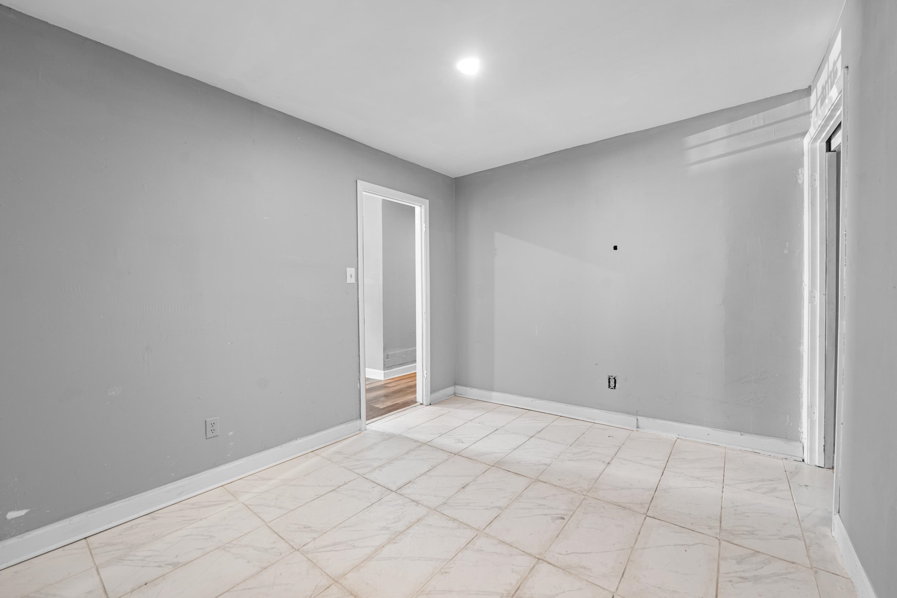 726 Harahan Road Memphis, TN 38109 - Photo 9 of 24 Spare room with marble look tiles and baseboards