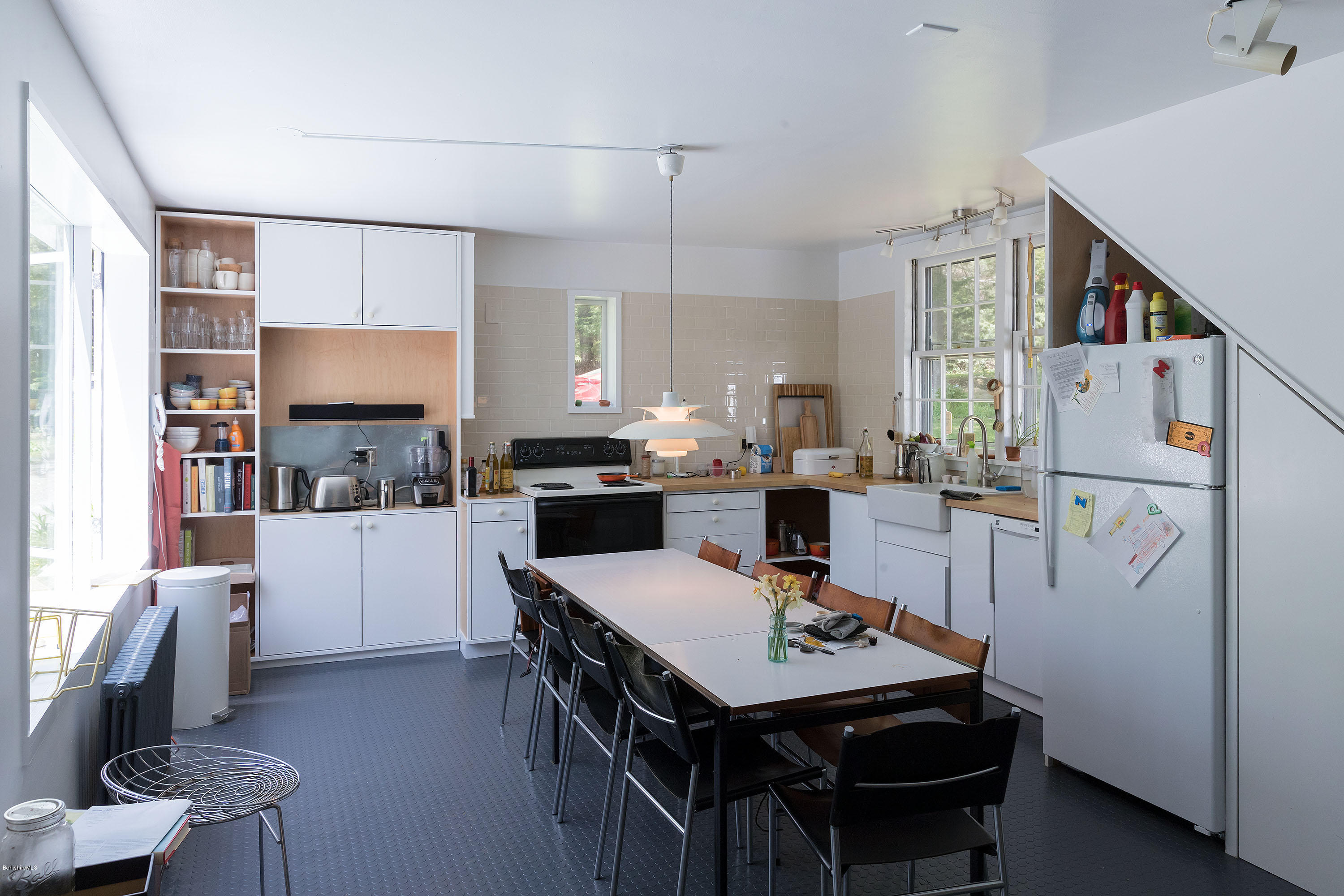 10 Tannery Road Sandisfield, MA 01255 - Photo 11 of 24 a kitchen with a sink a stove a refrigerator and a dining table with wooden floor