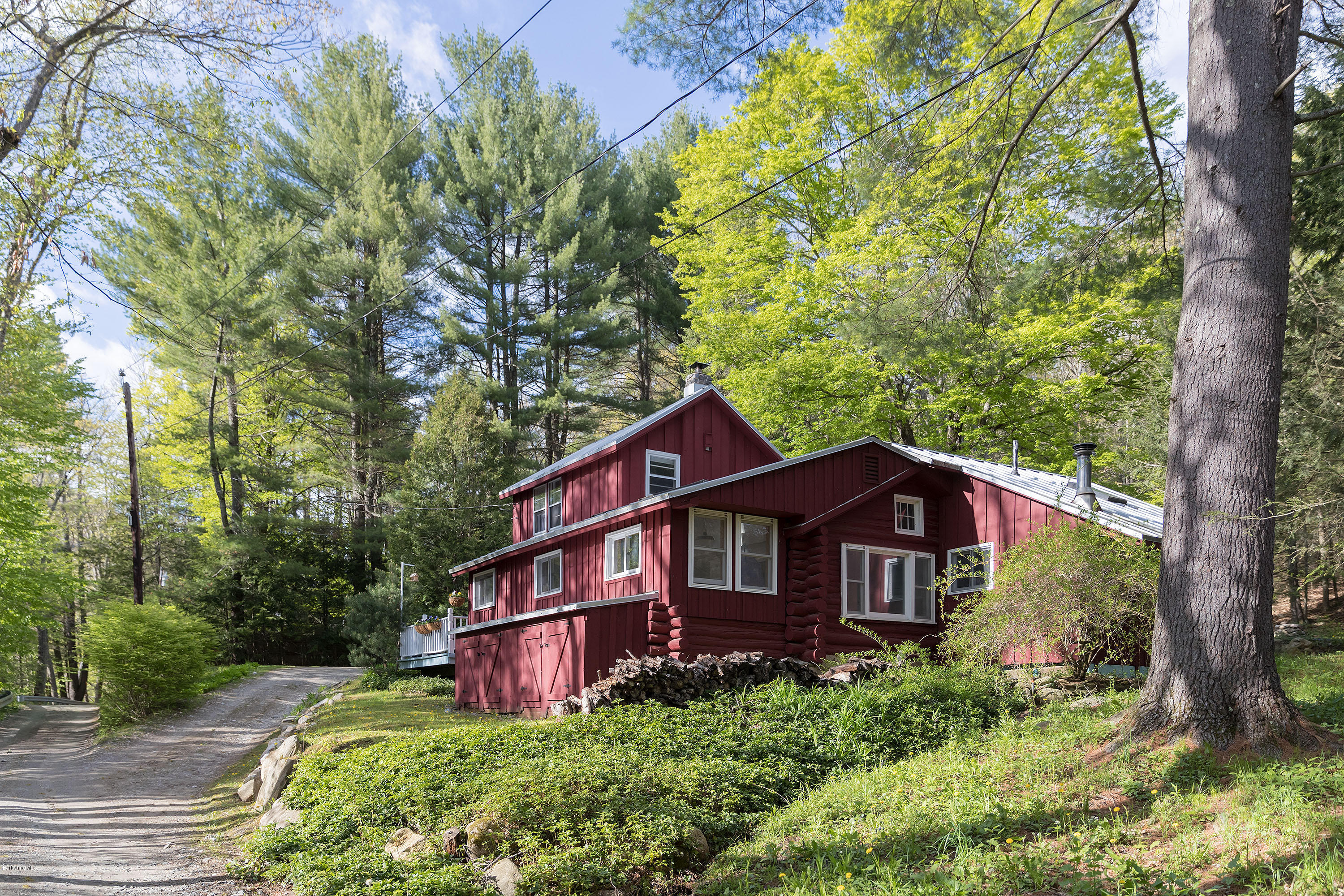 10 Tannery Road Sandisfield, MA 01255 - Photo 4 of 24 a view of a small house with a big yard plants and large trees