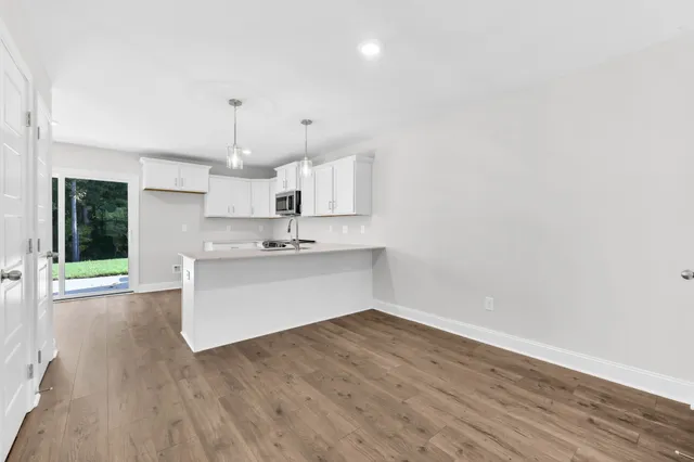 a view of kitchen with wooden floor and window