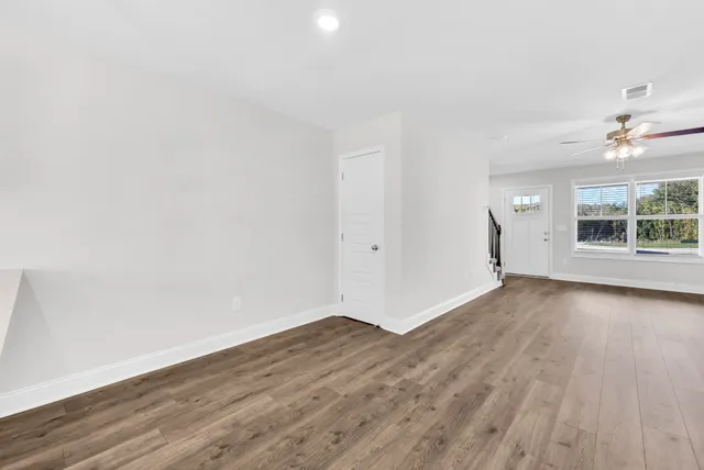 wooden floor in an empty room with a window