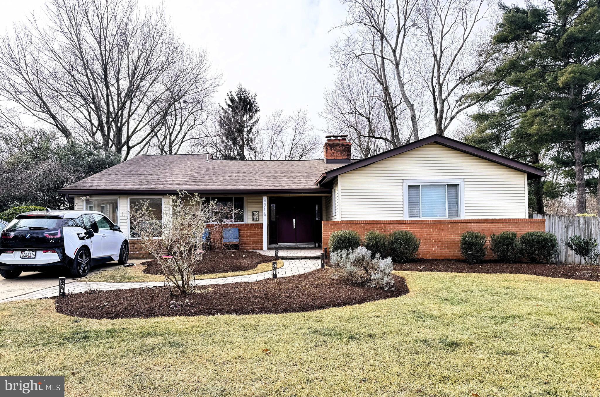 a front view of a house with a yard and a fire pit
