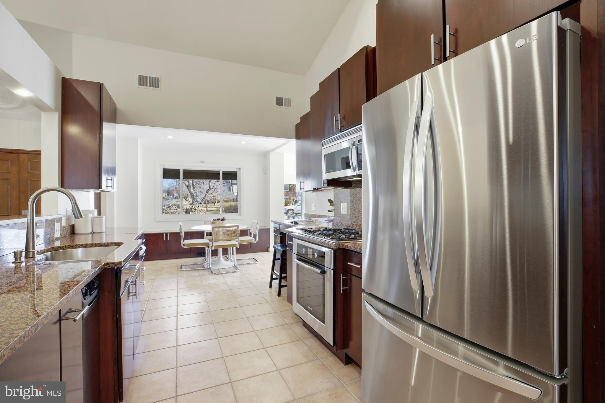 9914 Fernwood Road Bethesda, MD 20817 - Photo 14 of 61 a kitchen with stainless steel appliances a refrigerator sink and stove