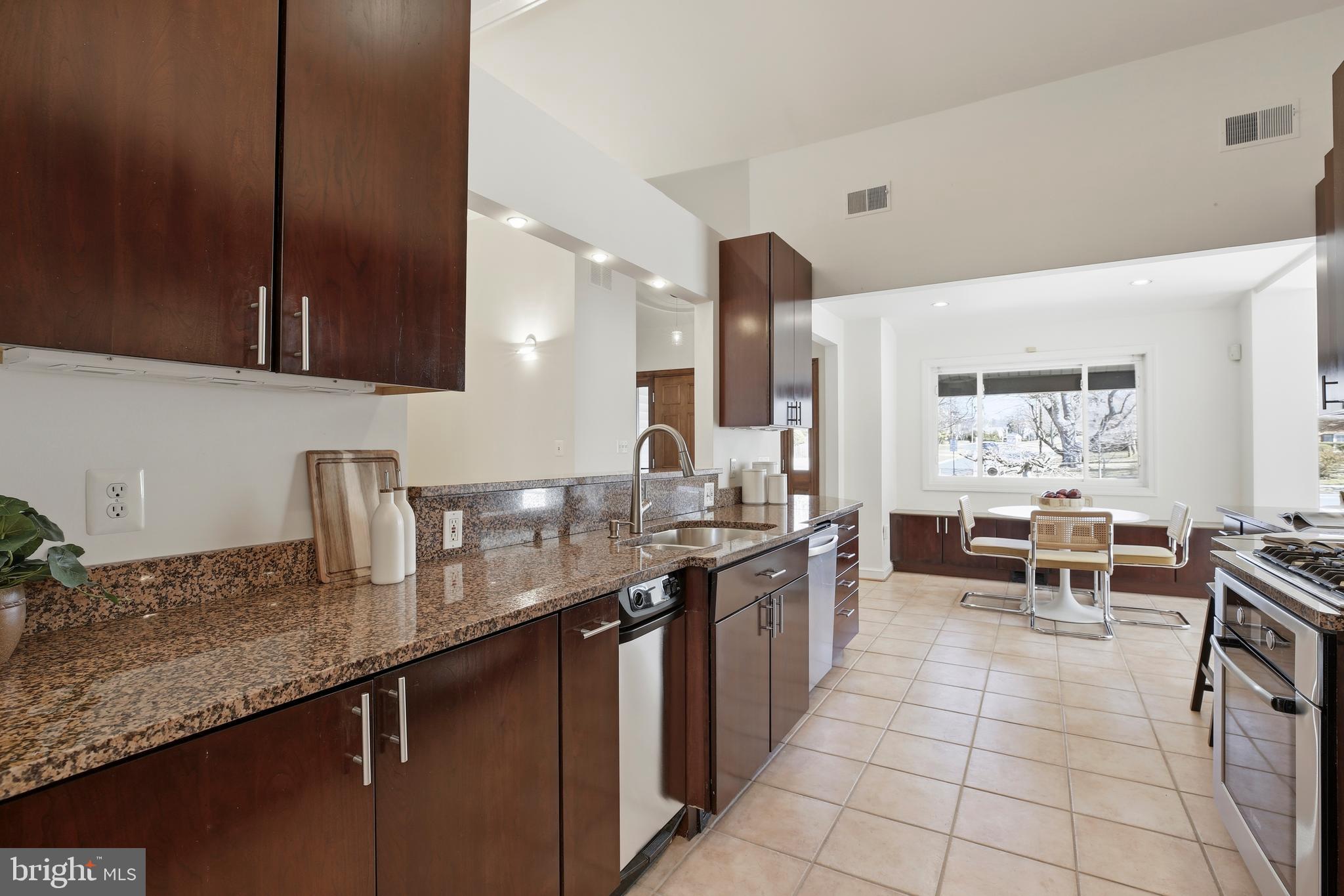 9914 Fernwood Road Bethesda, MD 20817 - Photo 15 of 61 a large kitchen with granite countertop a sink and cabinets