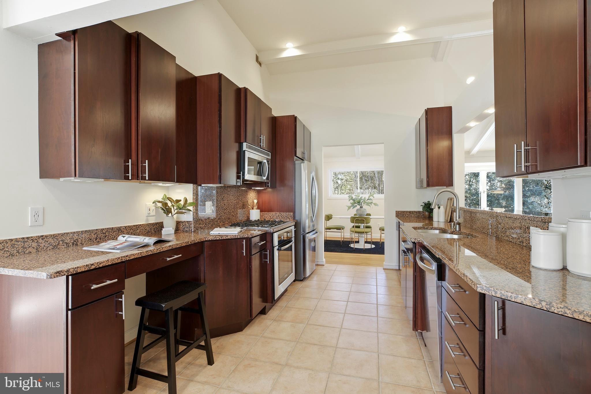 9914 Fernwood Road Bethesda, MD 20817 - Photo 16 of 61 a kitchen with stainless steel appliances granite countertop wooden cabinets a stove top oven a sink and dishwasher