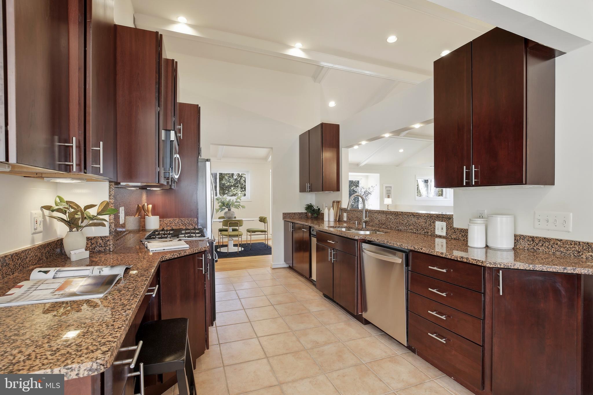 9914 Fernwood Road Bethesda, MD 20817 - Photo 17 of 61 a large kitchen with granite countertop a large counter top appliances and cabinets