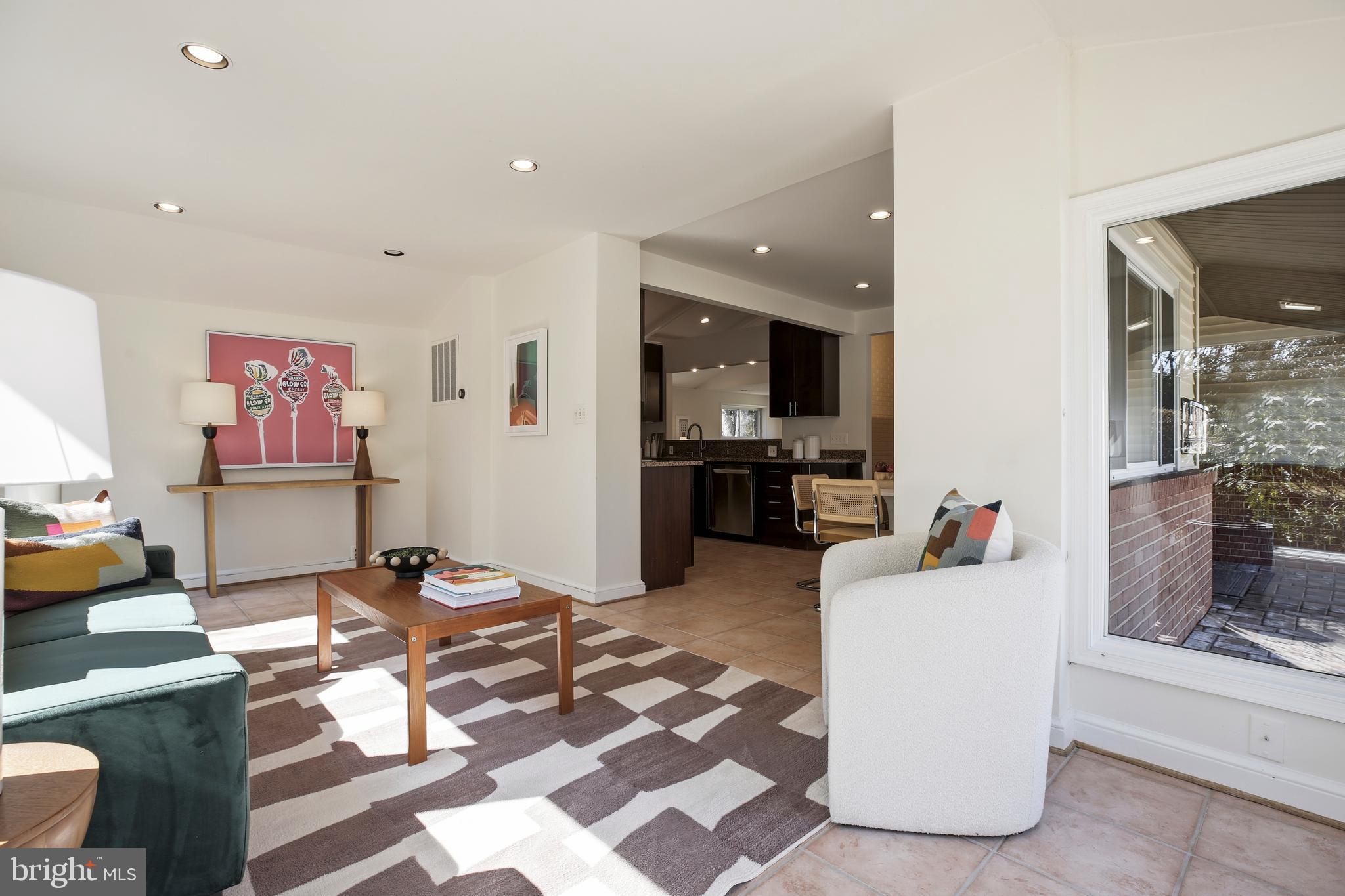 9914 Fernwood Road Bethesda, MD 20817 - Photo 19 of 61 a living room with furniture and a flat screen tv