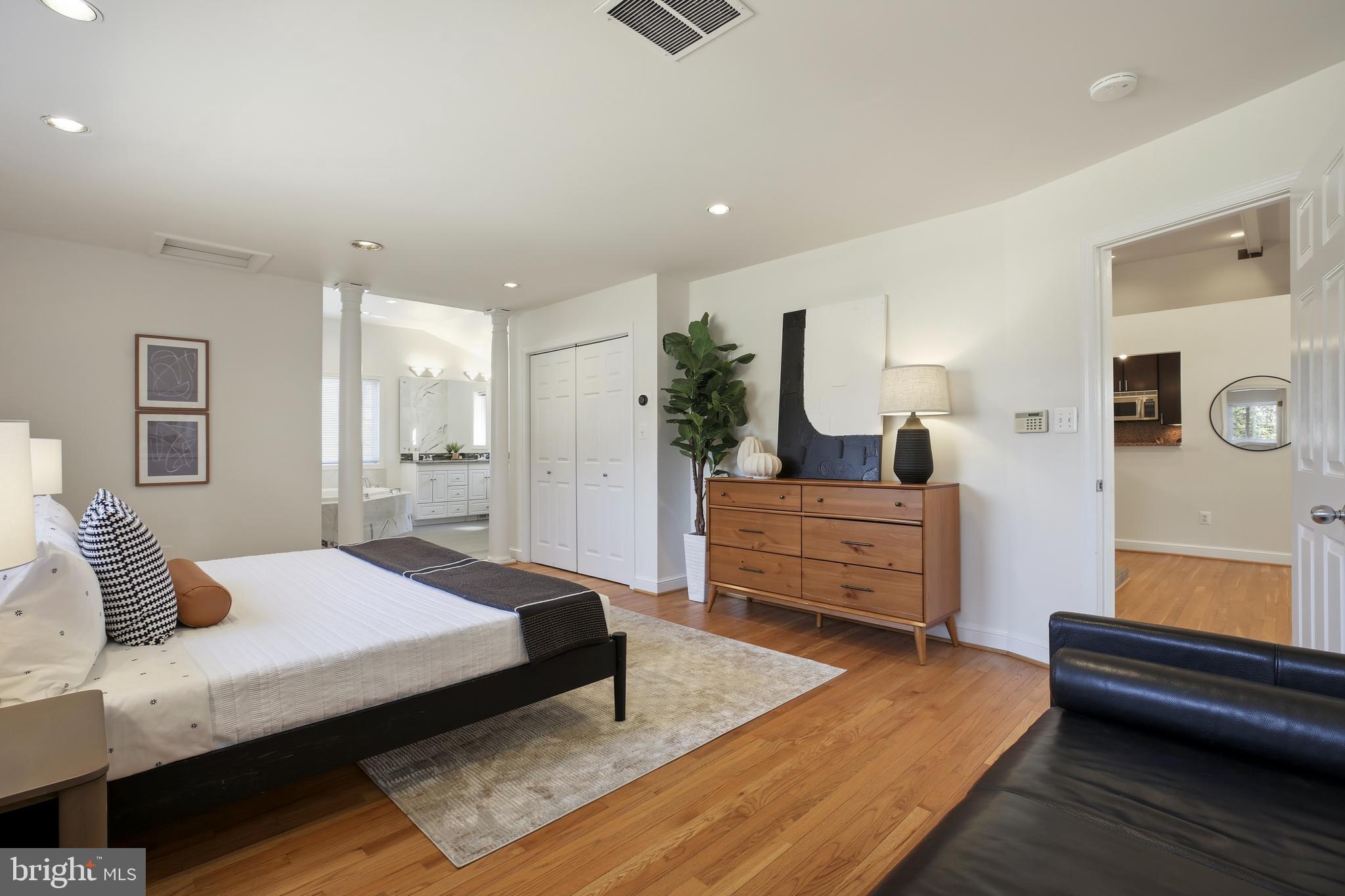 9914 Fernwood Road Bethesda, MD 20817 - Photo 25 of 61 a bedroom with a bed and wooden floor