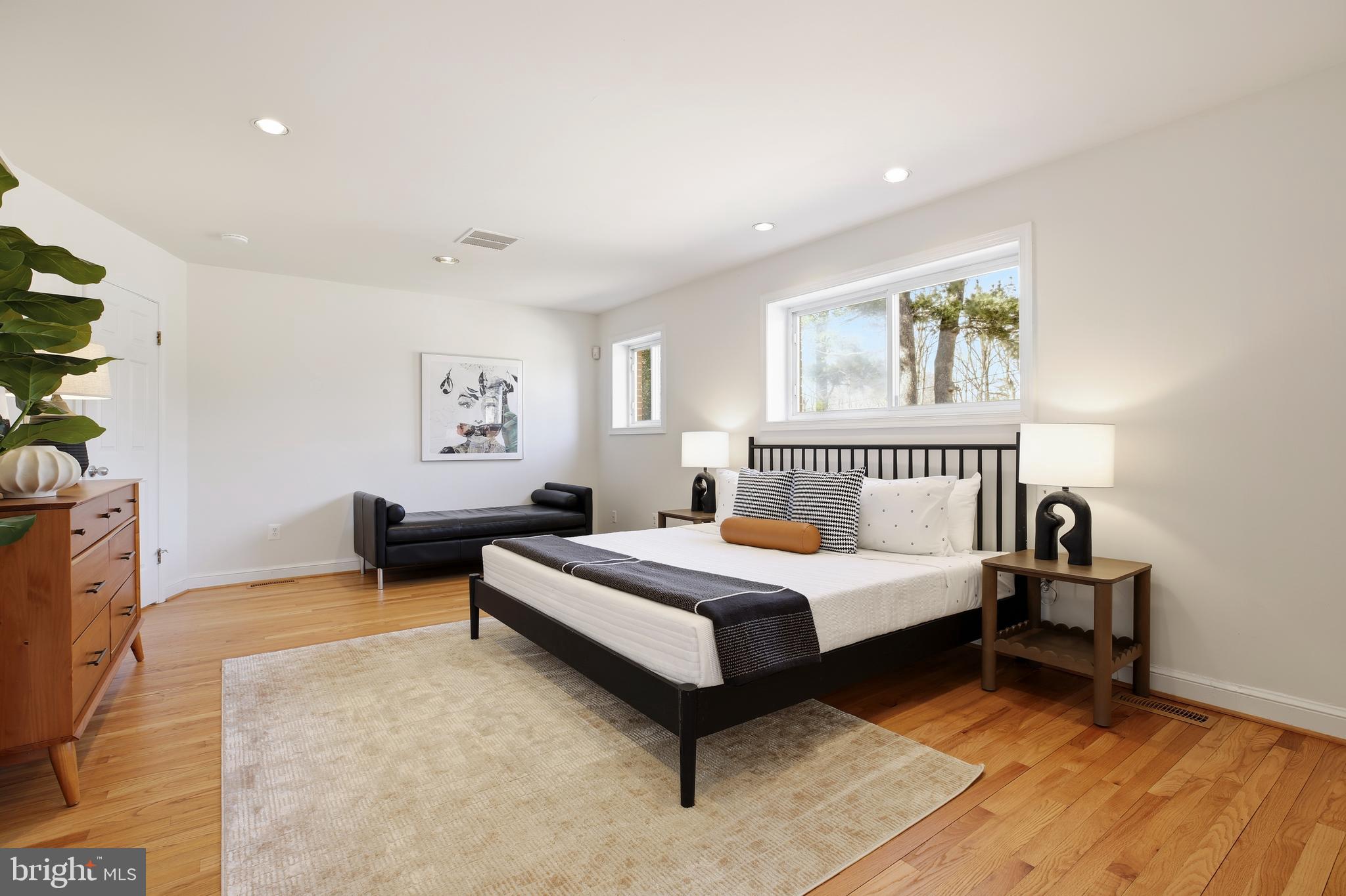 9914 Fernwood Road Bethesda, MD 20817 - Photo 27 of 61 a spacious bedroom with a bed and a table in it