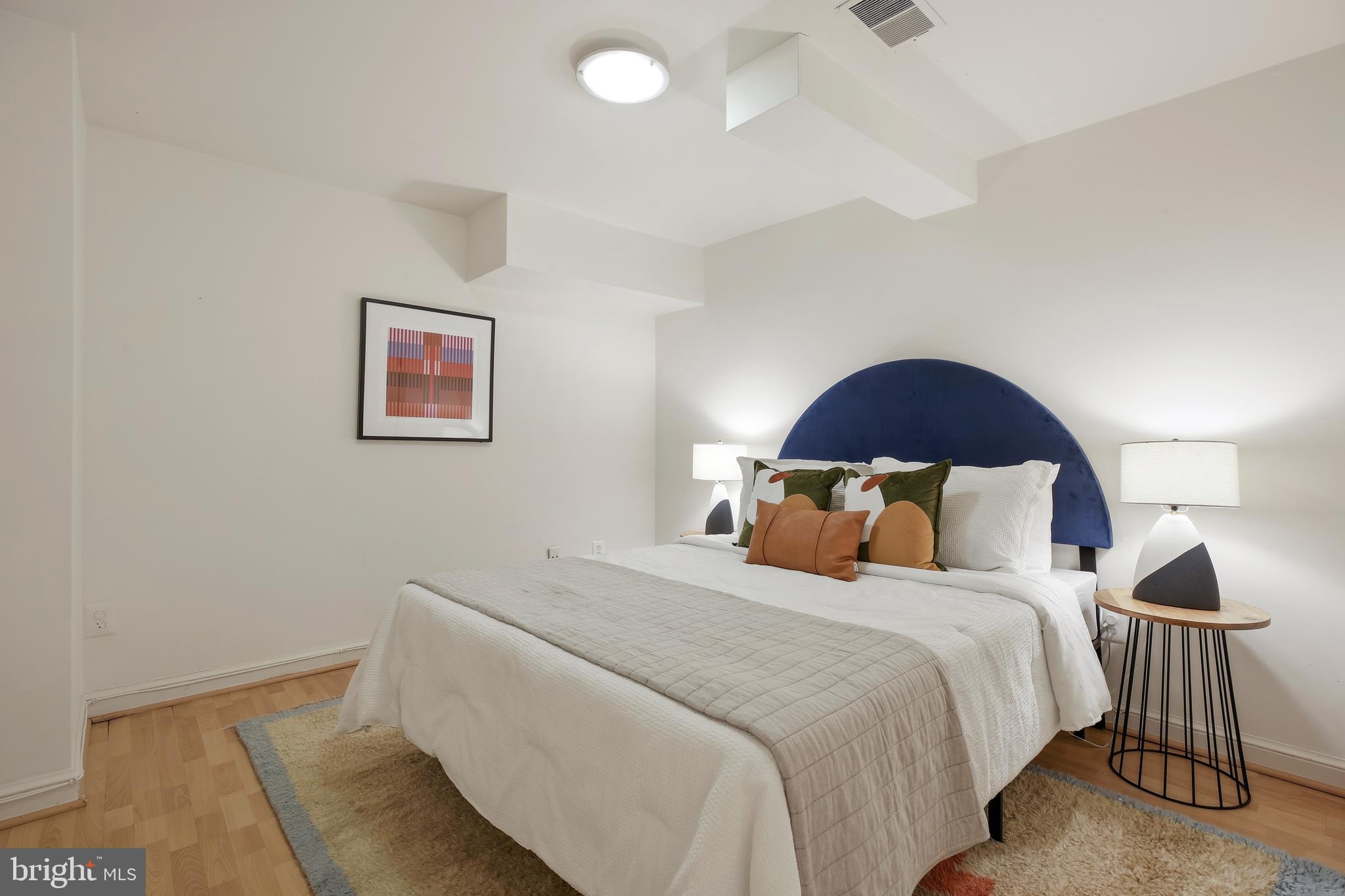 9914 Fernwood Road Bethesda, MD 20817 - Photo 50 of 61 a bedroom with a bed and a painting on the wall