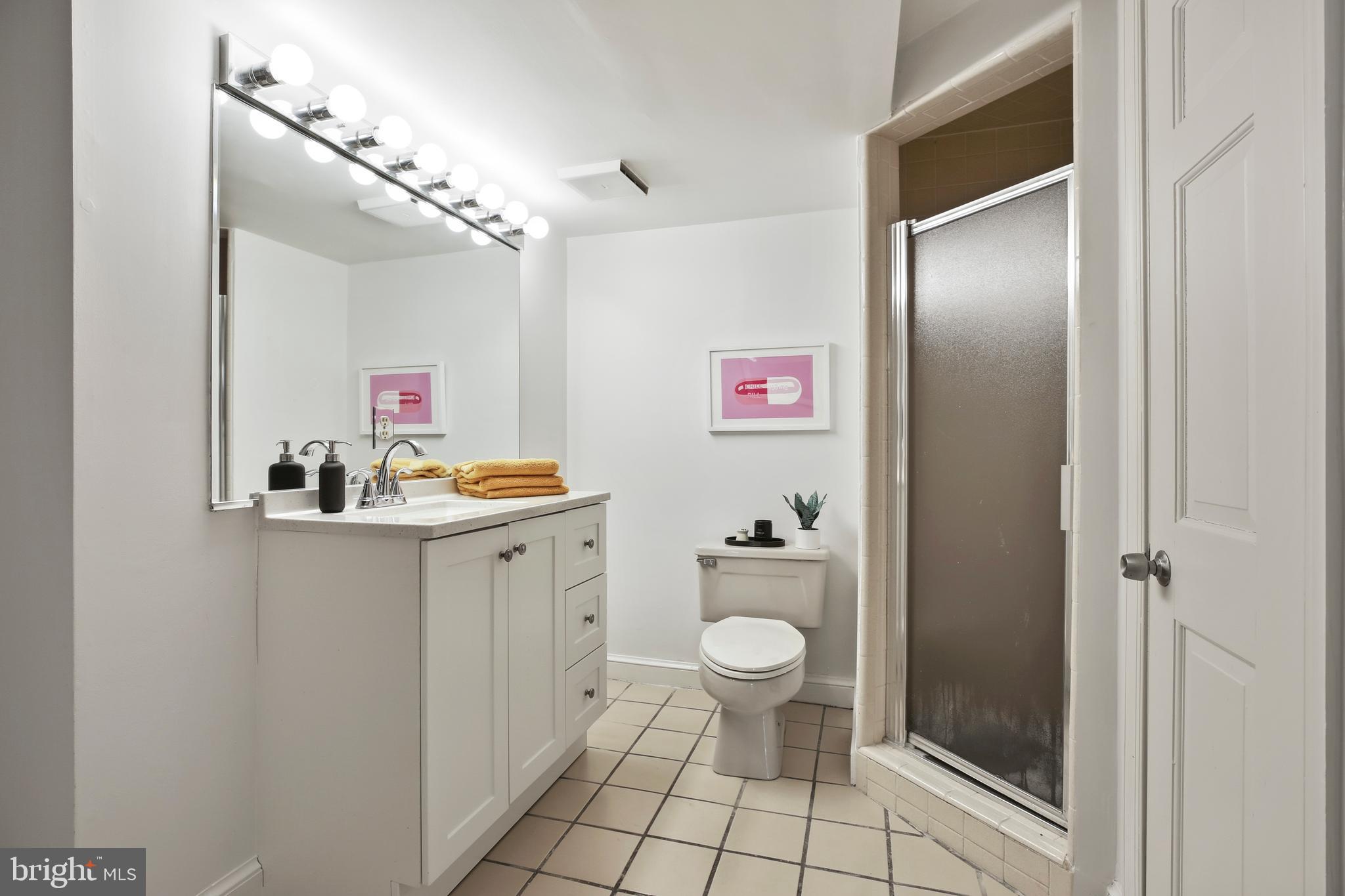 9914 Fernwood Road Bethesda, MD 20817 - Photo 53 of 61 a bathroom with a granite countertop sink toilet and shower