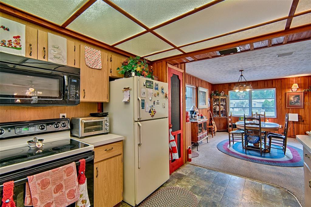 6537 Triest Avenue Keystone Heights, FL 32656 - Photo 13 of 36 a kitchen with stainless steel appliances granite countertop a refrigerator a stove and a sink with cabinets
