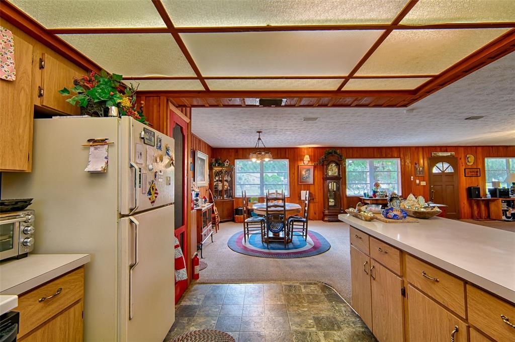 6537 Triest Avenue Keystone Heights, FL 32656 - Photo 14 of 36 a view of a kitchen with a sink and refrigerator in a kitchen