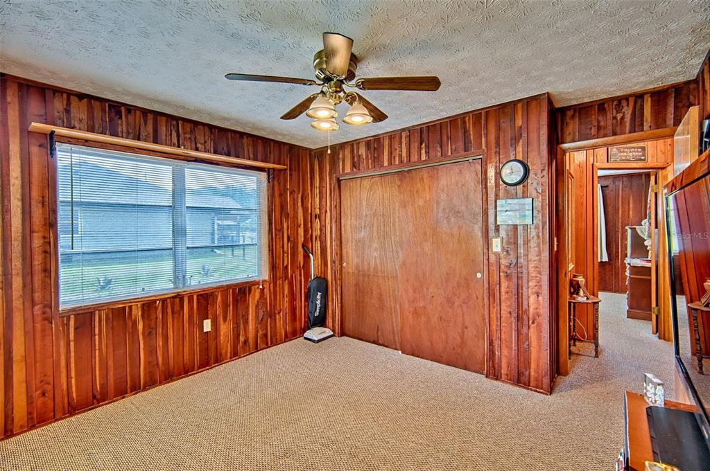 6537 Triest Avenue Keystone Heights, FL 32656 - Photo 19 of 36 a view of a hallway with a ceiling fan