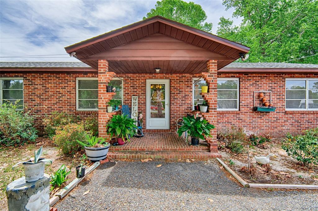 6537 Triest Avenue Keystone Heights, FL 32656 - Photo 2 of 36 a front view of a house with garden