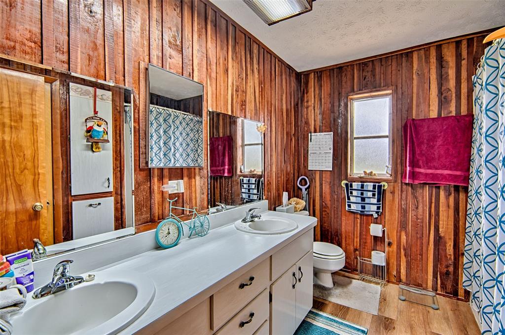 6537 Triest Avenue Keystone Heights, FL 32656 - Photo 21 of 36 a bathroom with a double vanity sink a mirror and a shower