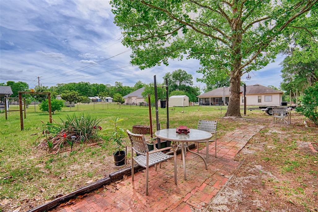 6537 Triest Avenue Keystone Heights, FL 32656 - Photo 28 of 36 a view of a chairs and table in backyard of the house