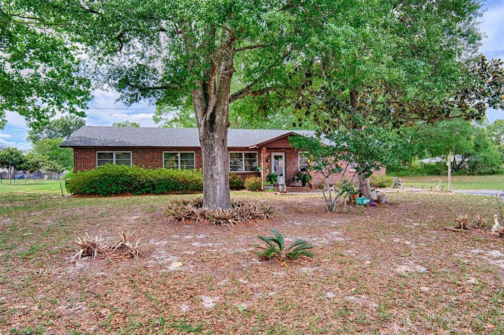 6537 Triest Avenue Keystone Heights, FL 32656 - Photo 32 of 36 a front view of a house with a garden