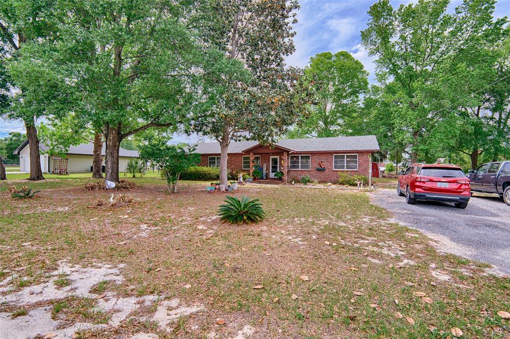 6537 Triest Avenue Keystone Heights, FL 32656 - Photo 34 of 36 a front view of a house with a garden