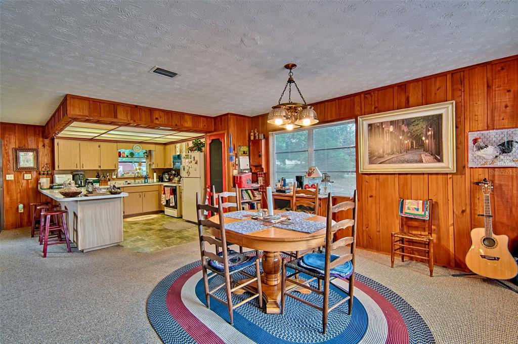 6537 Triest Avenue Keystone Heights, FL 32656 - Photo 9 of 36 a dining room with furniture and a large window