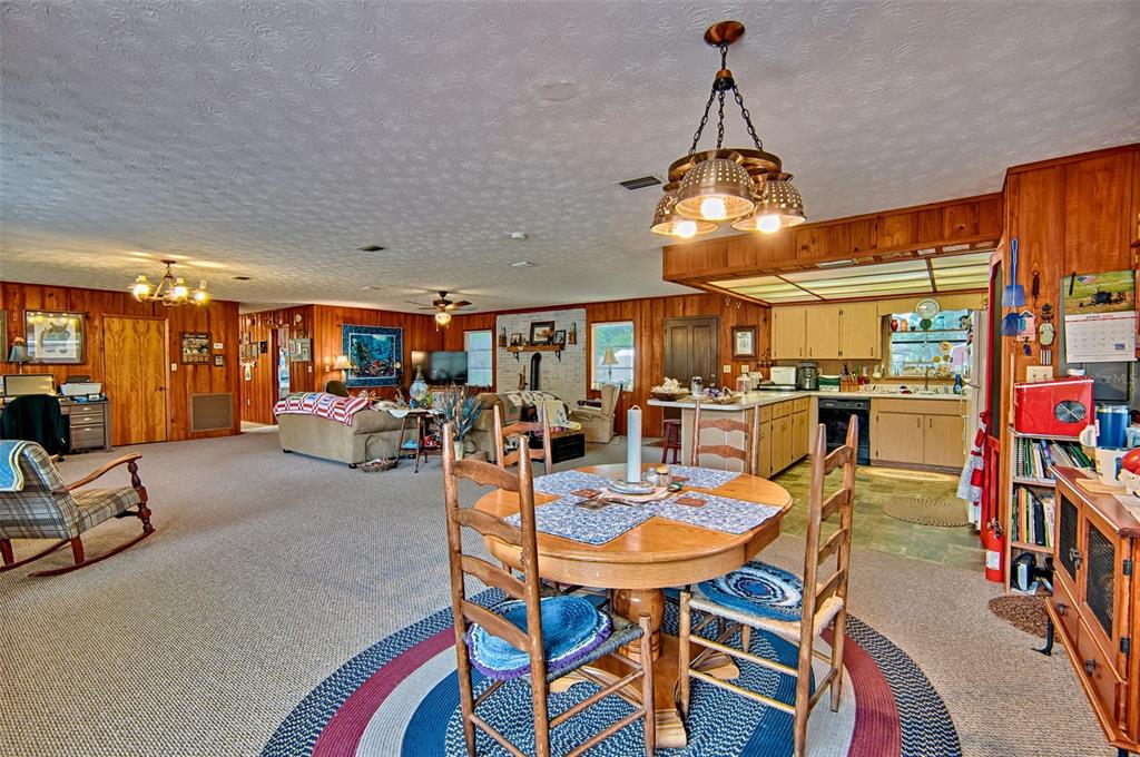 6537 Triest Avenue Keystone Heights, FL 32656 - Photo 10 of 36 a dining room with furniture and a chandelier