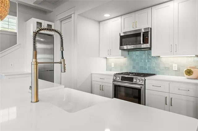 a kitchen with a refrigerator stove and microwave