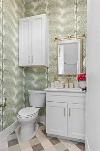 a bathroom with a toilet sink and mirror