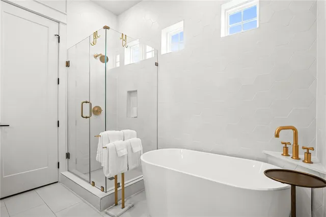 a bathroom with a sink a tub and shower