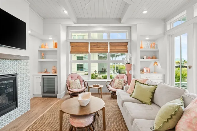 a living room with furniture a flat screen tv and a fireplace