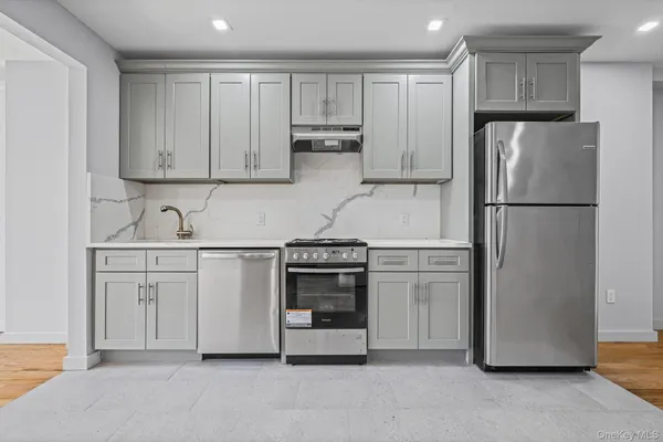 a kitchen with a refrigerator sink and cabinets